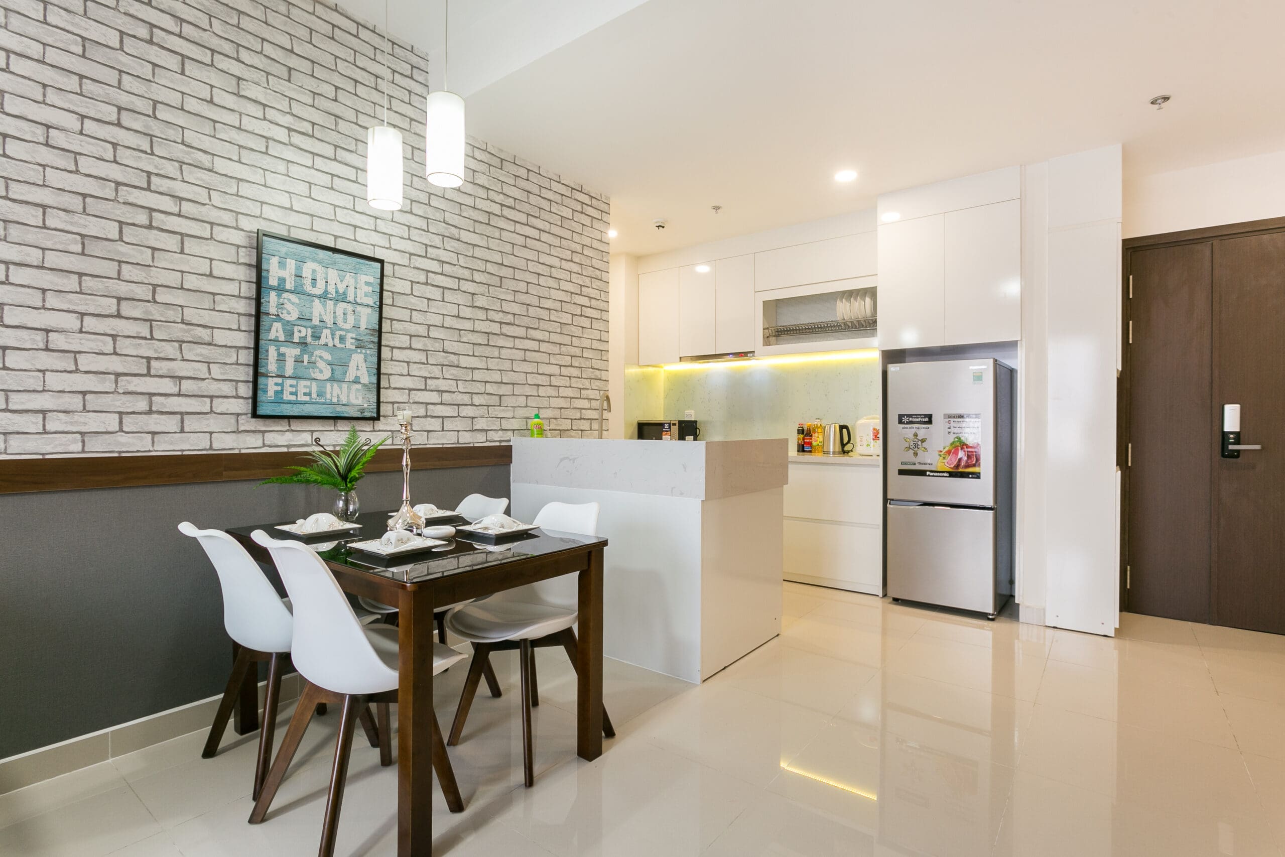 Dining area and modern kitchen in RiverGate Residence two-bedroom apartment