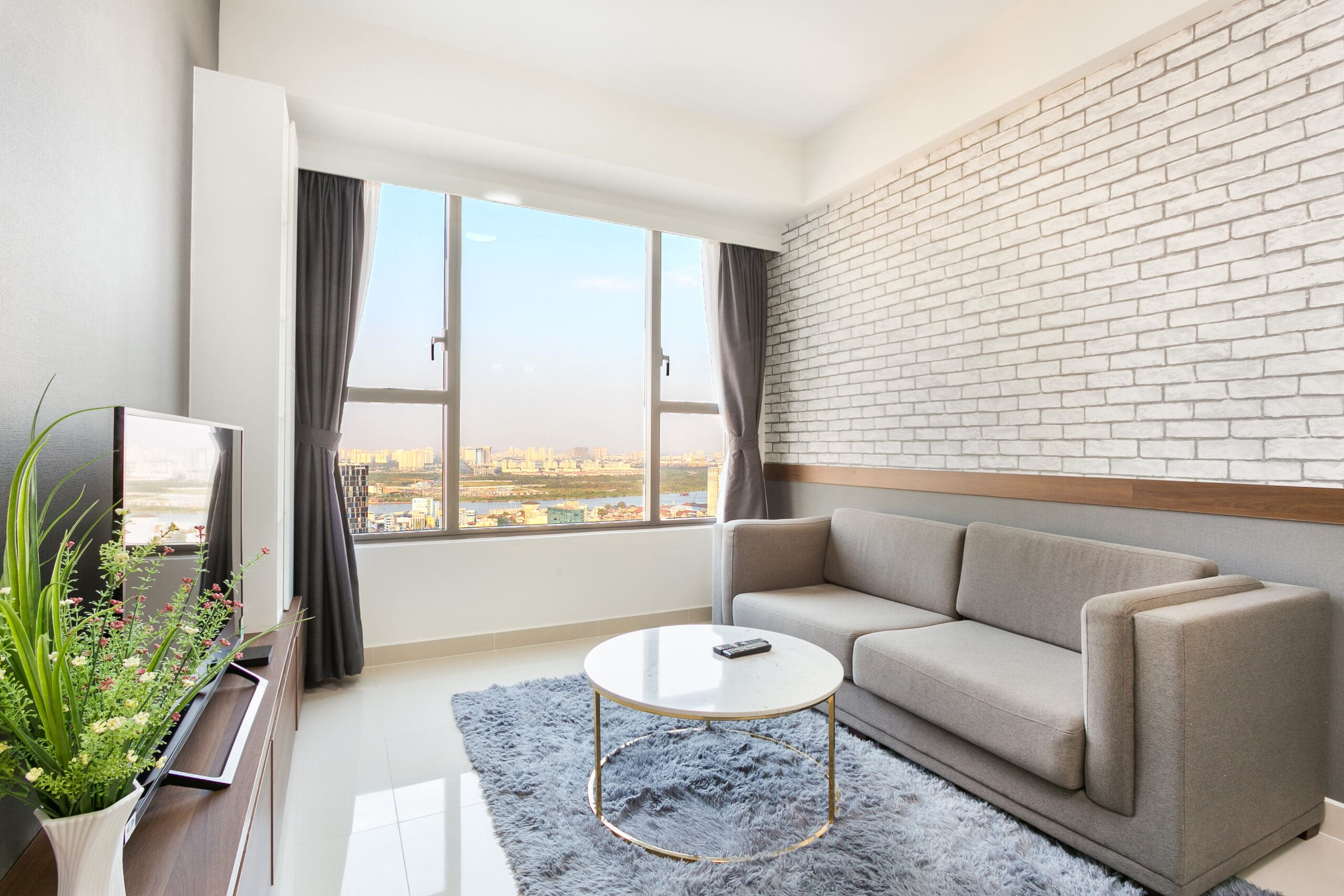 Elegant living room with panoramic city views at RiverGate Residence Two-Bedroom Apartment