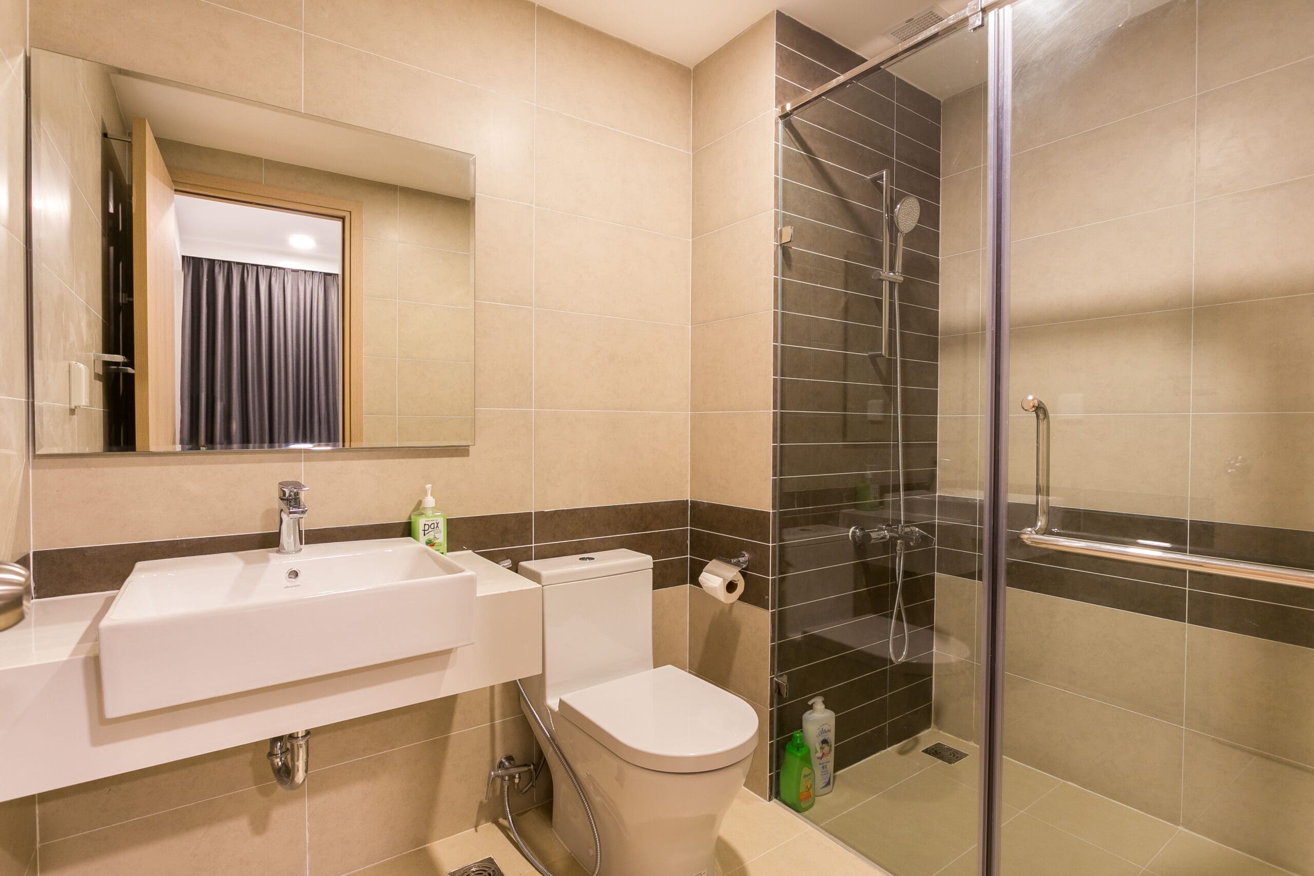 Elegant private bathroom design with spacious glass shower at RiverGate Residence