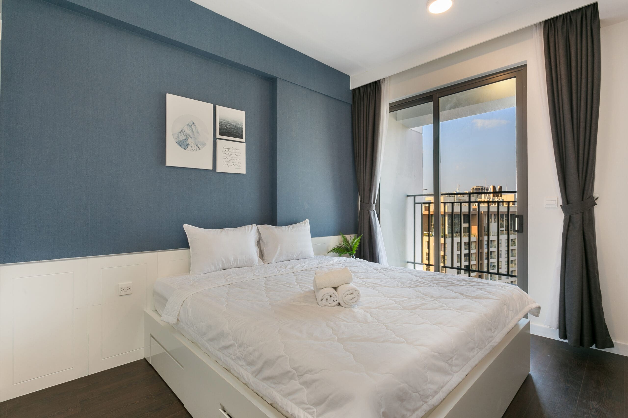 Second bedroom with private balcony at RiverGate Residence Apartment