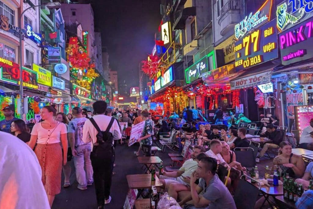 Du khách nước ngoài và người Việt ngồi uống bia, tán gẫu tại các quán vỉa hè ở phố Tây Bùi Viện, TP.HCM